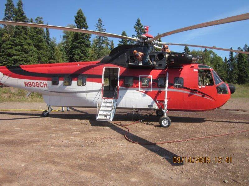 A Sikorski helicopter is given a last-minute check before the installation project